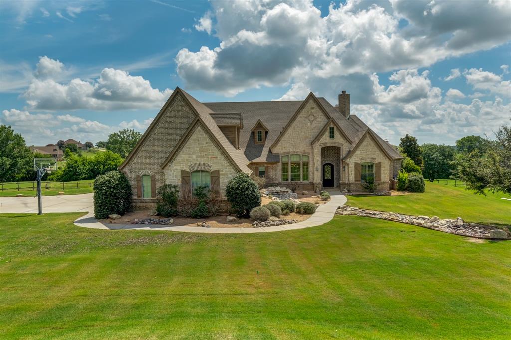 a front view of house with yard and green space