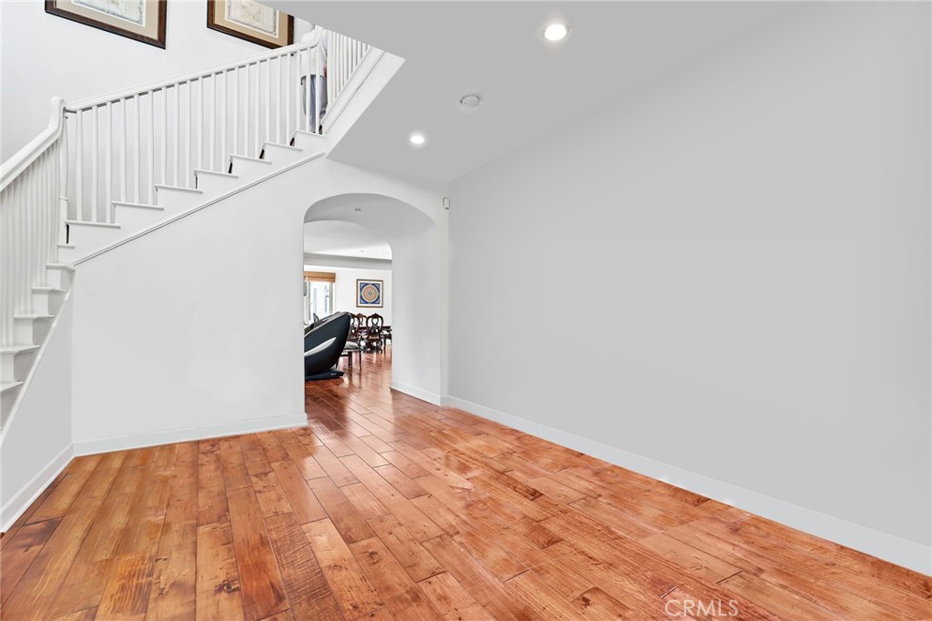 a view of entryway and hall with wooden floor