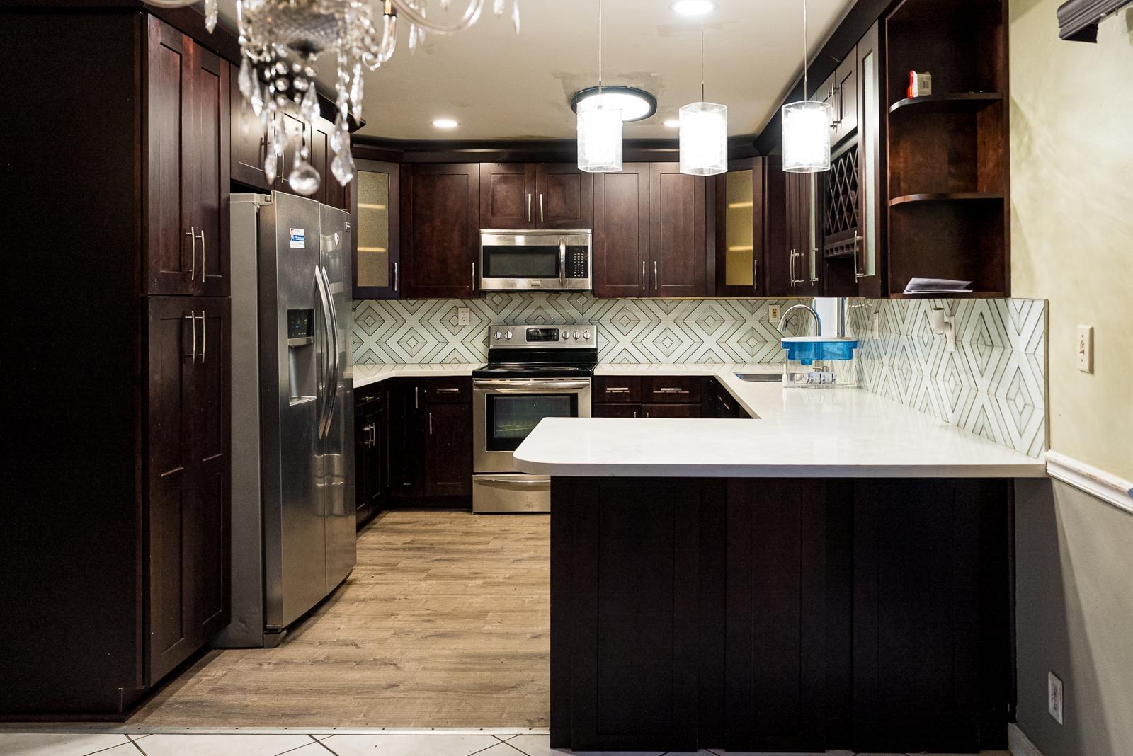 a kitchen with stainless steel appliances a sink stove and refrigerator