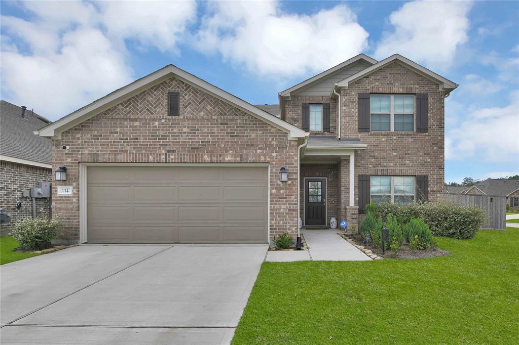 a front view of a house with a yard and garage