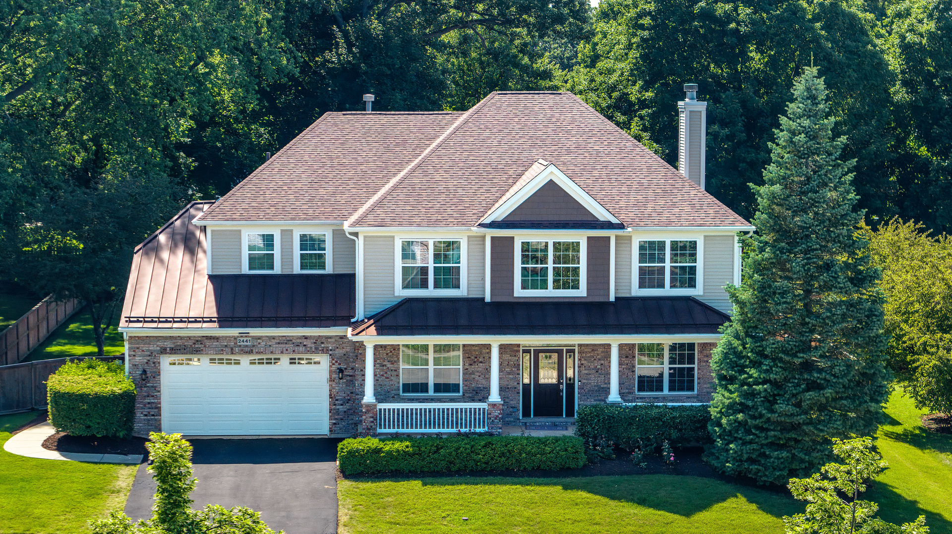 a aerial view of a house with yard and green space