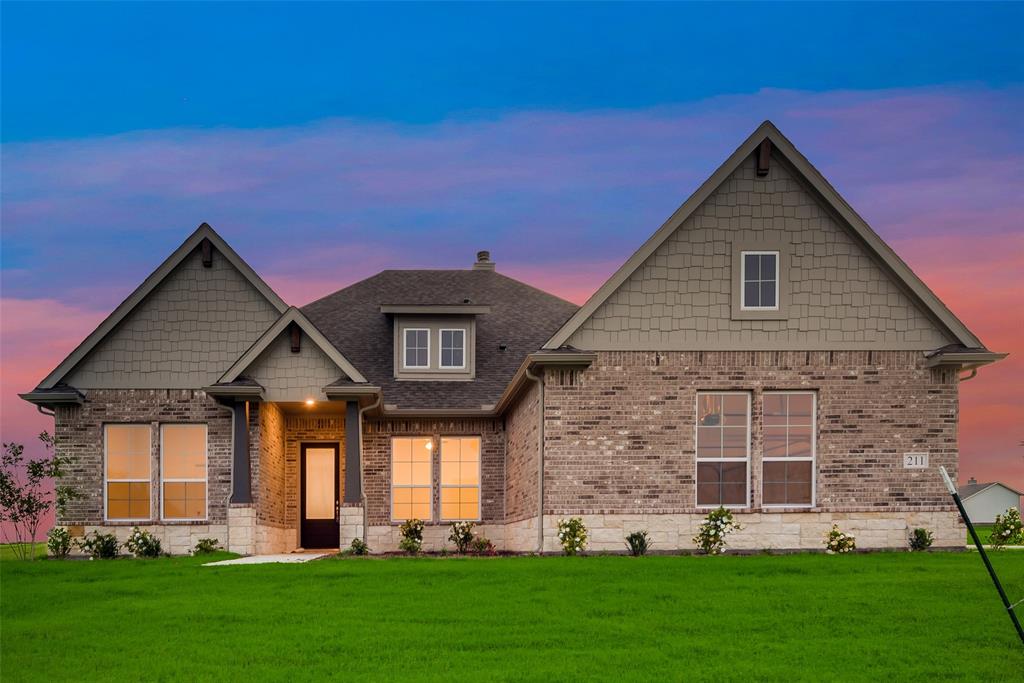 a front view of a house with a yard