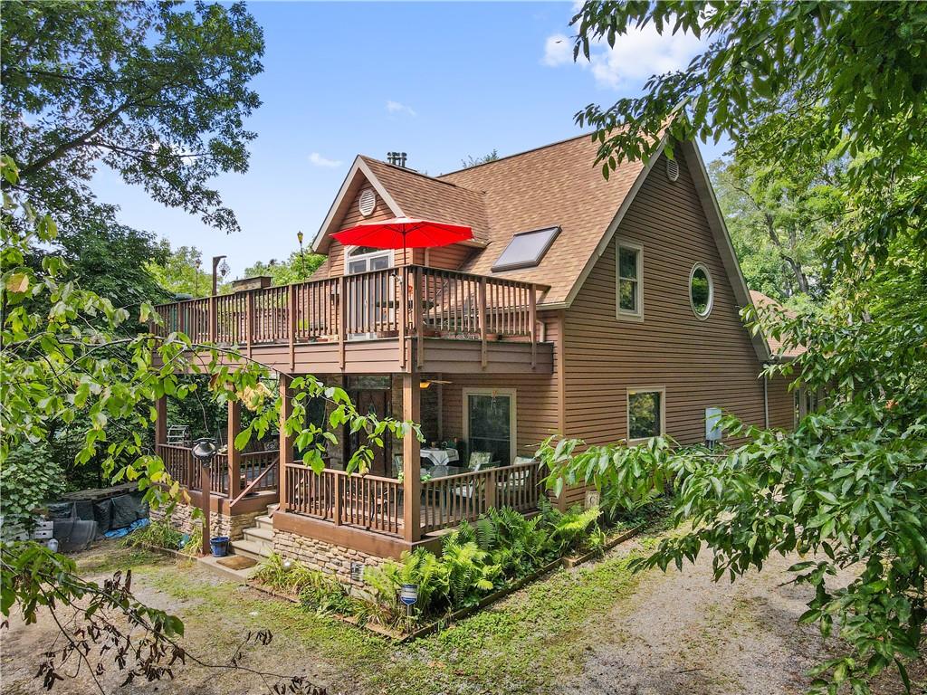 a view of a house with backyard and sitting area