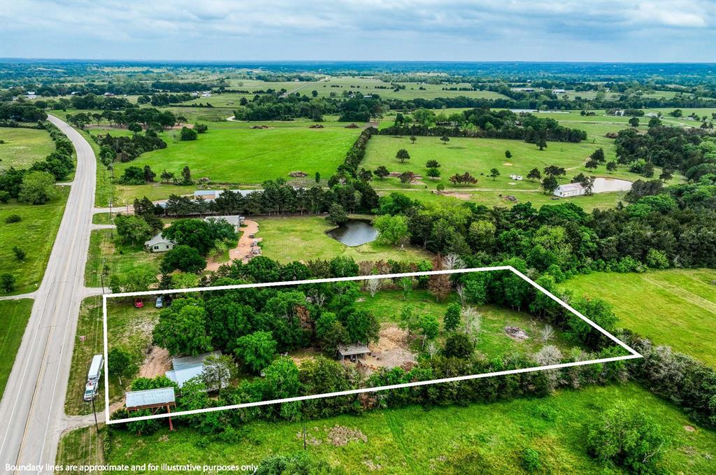 an aerial view of a houses with a garden