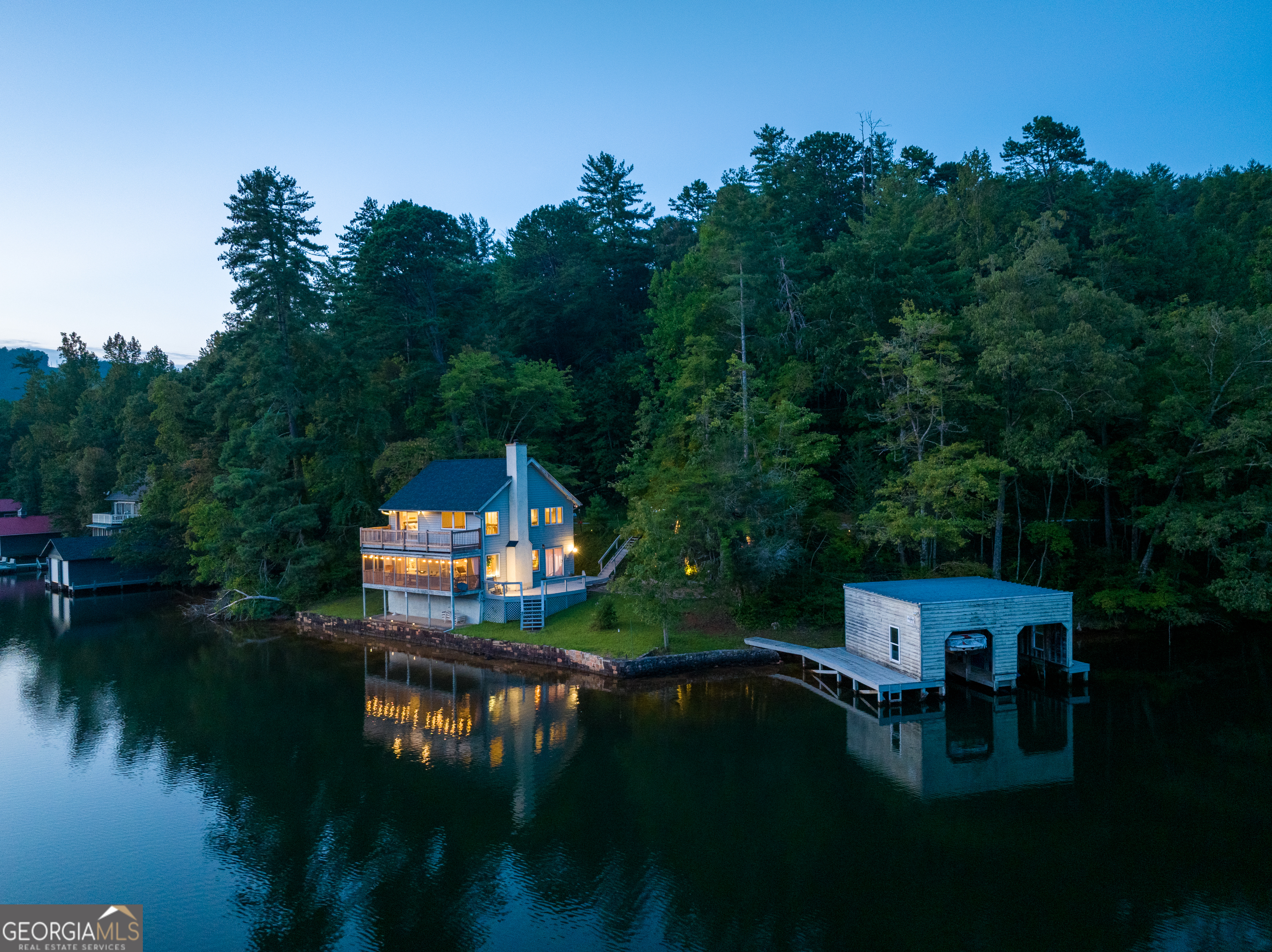 a view of house with garden and lake view