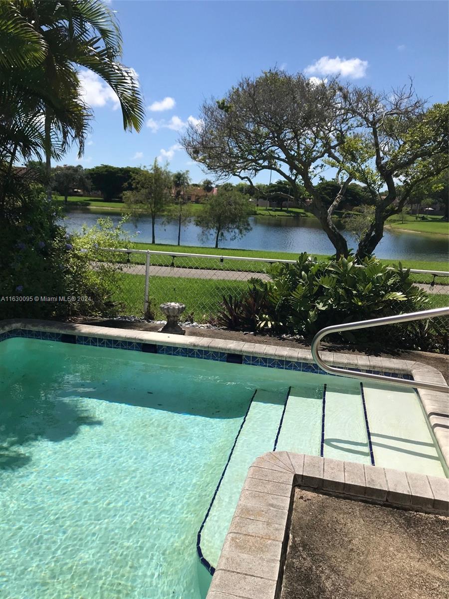 a view of a yard with a swimming pool