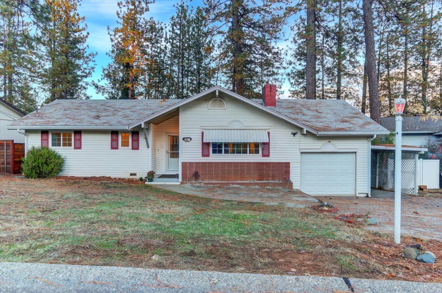 a house that has a tree in front of it