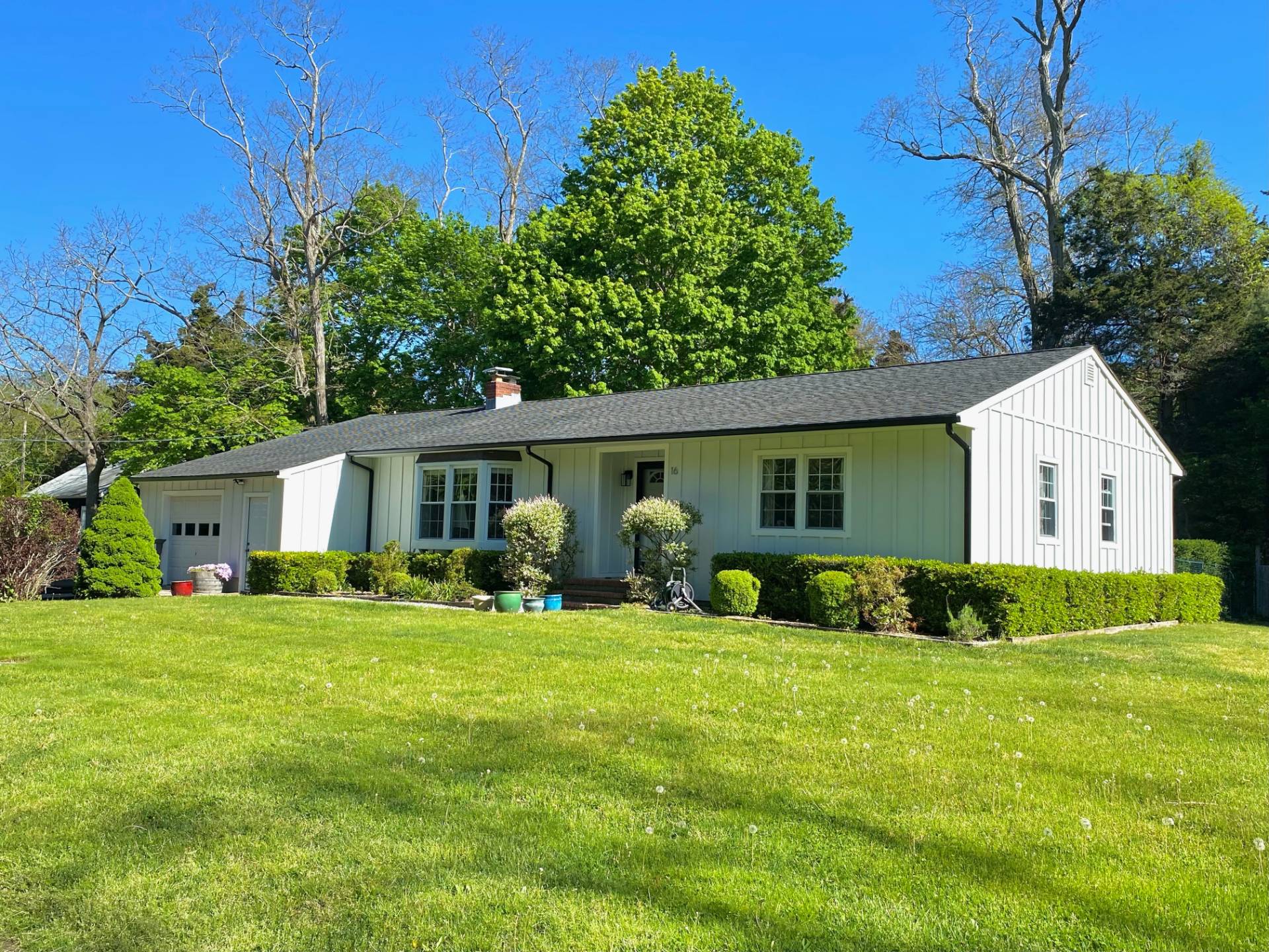 a front view of house with yard and green space