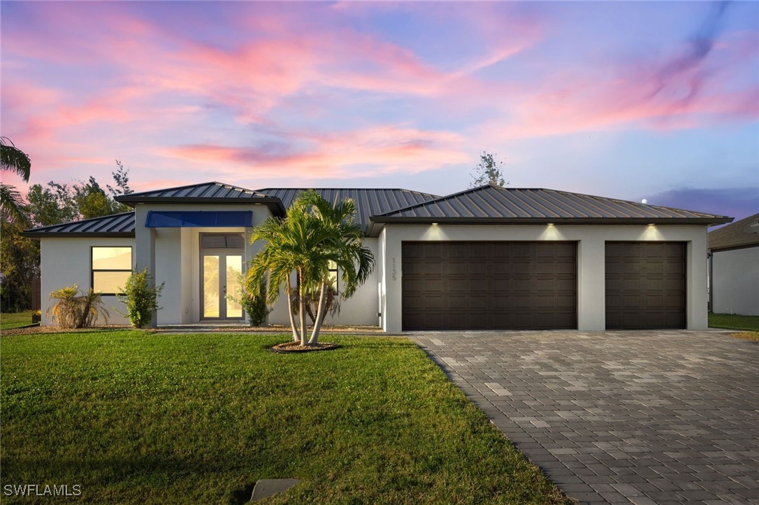 a front view of a house with a yard and garage