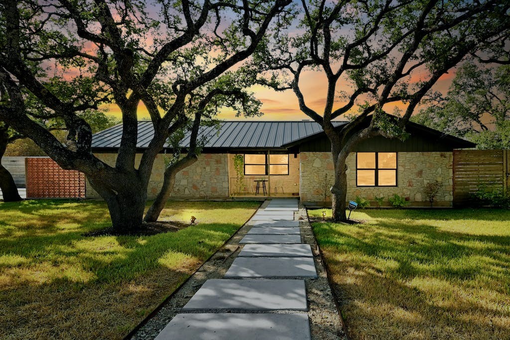 a front view of a house with garden