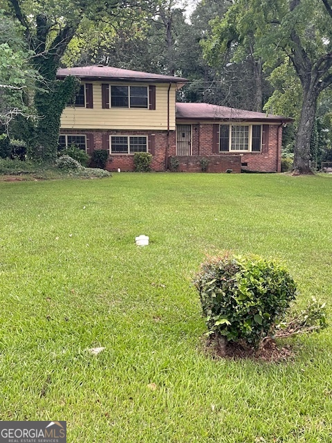 a view of a house with a yard and sitting area