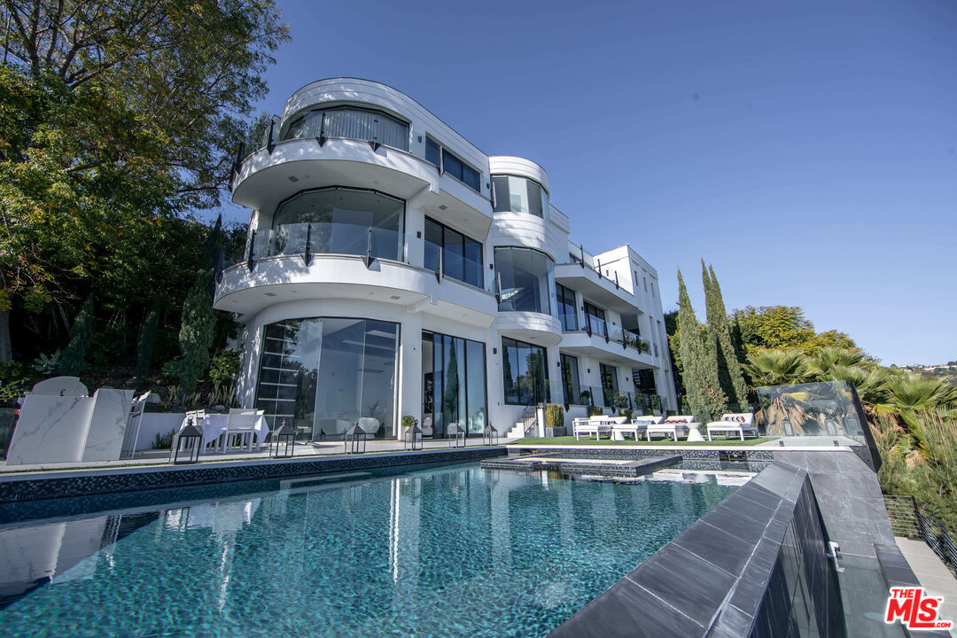 a view of a swimming pool with outdoor seating