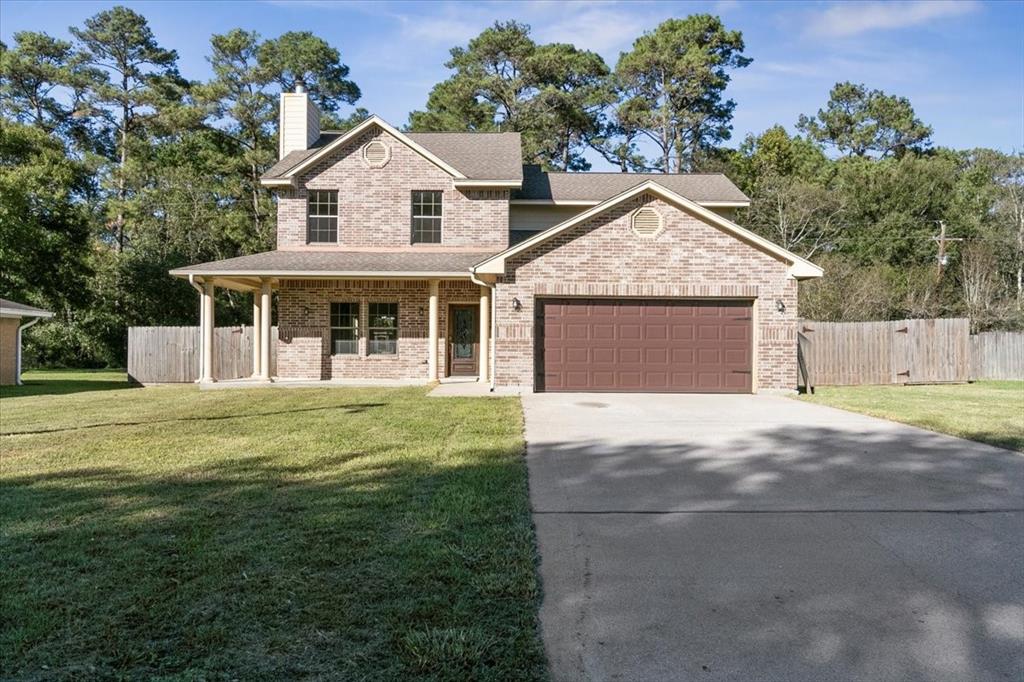 a view of a big house with a big yard and large tree