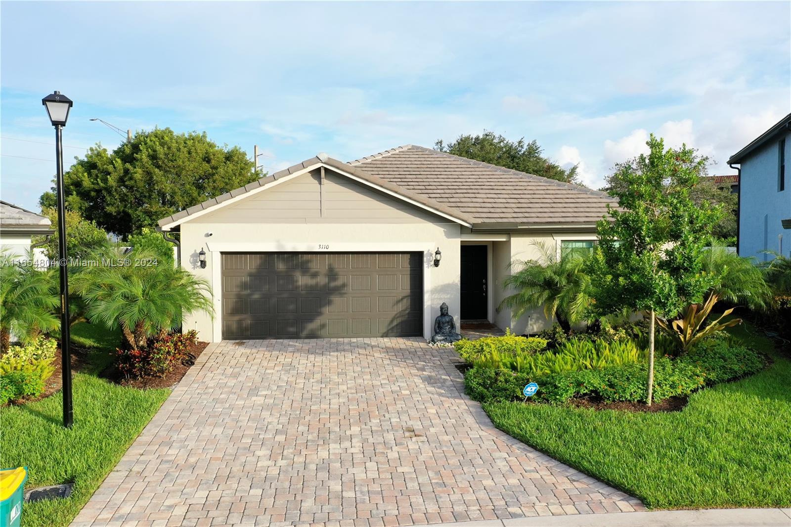 a front view of a house with a garden