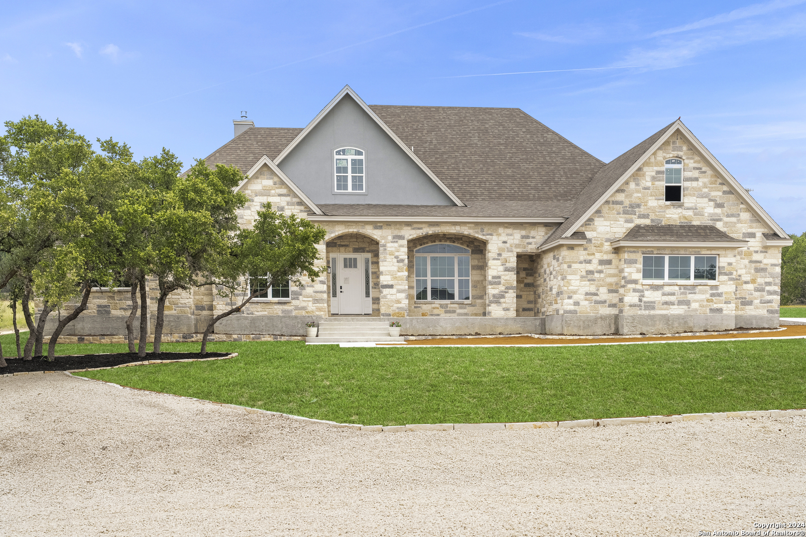 a front view of a house with a yard