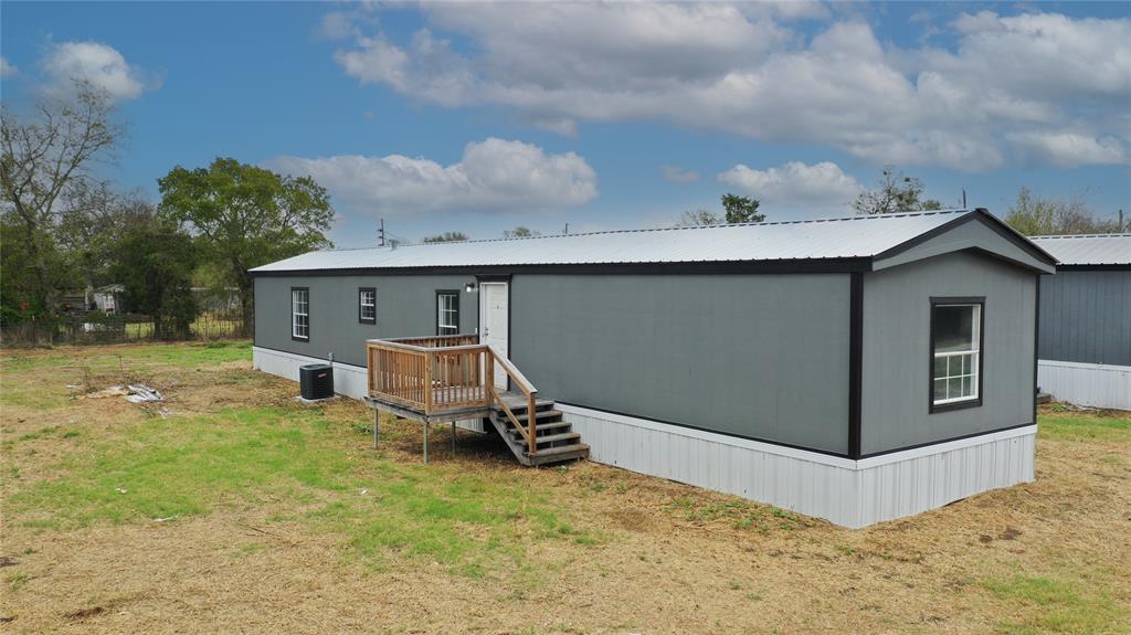 a view of a house with a yard and sitting area