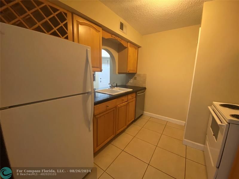 a kitchen with a refrigerator and a stove