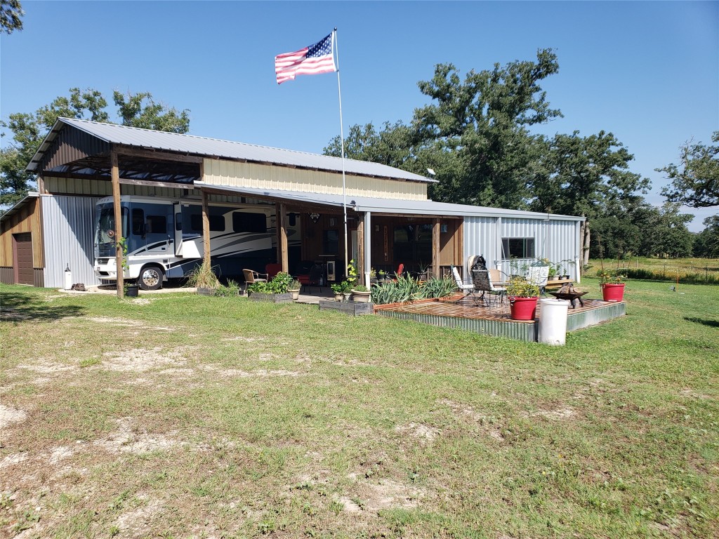 a view of a house with sitting area and garden