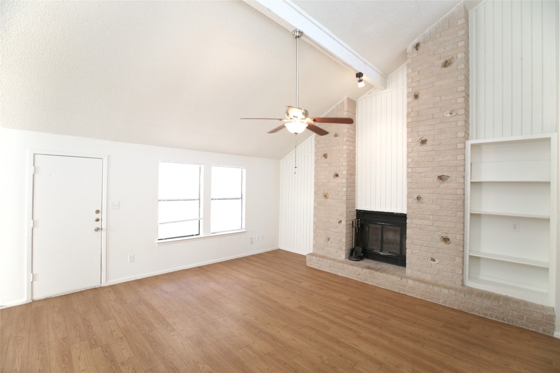 an empty room with windows and cabinet