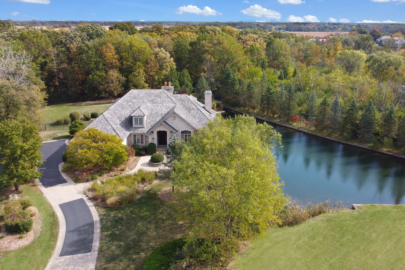 a view of a house with a yard and a large pool