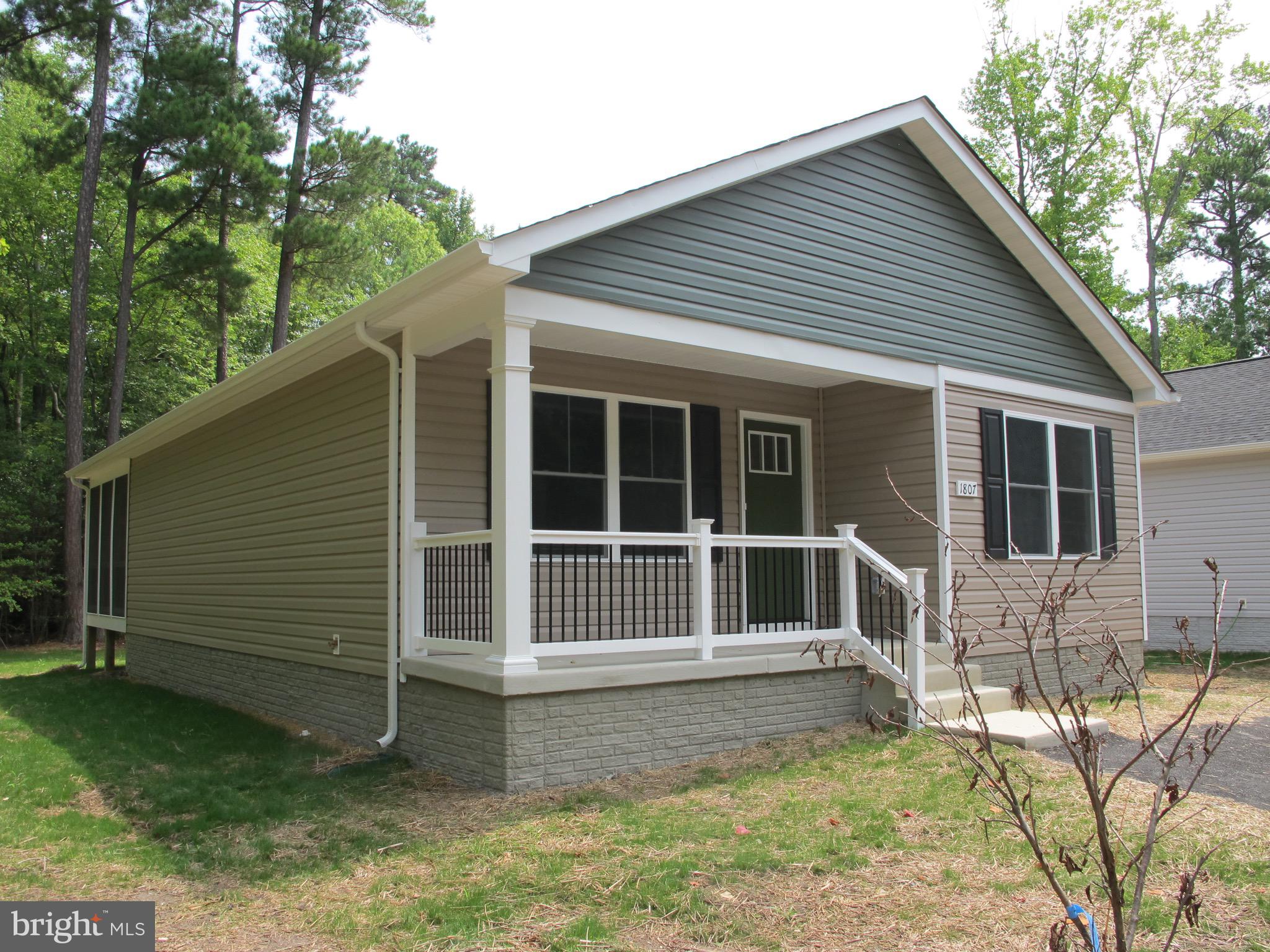 a house with a white roof and wooden fence