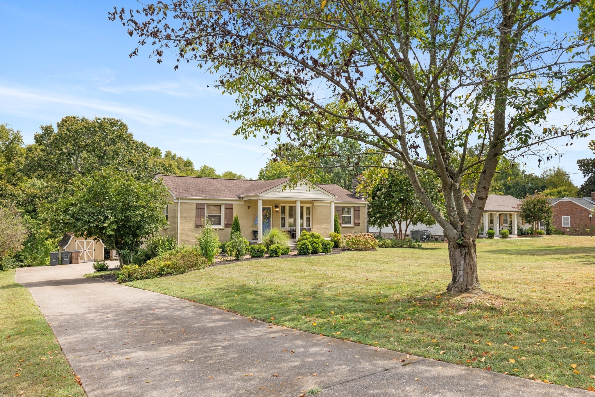 a front view of a house with a garden