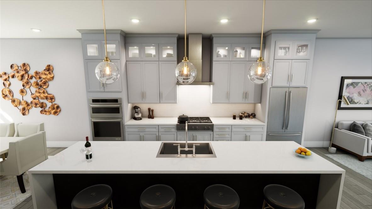 a kitchen with kitchen island a sink appliances and cabinets