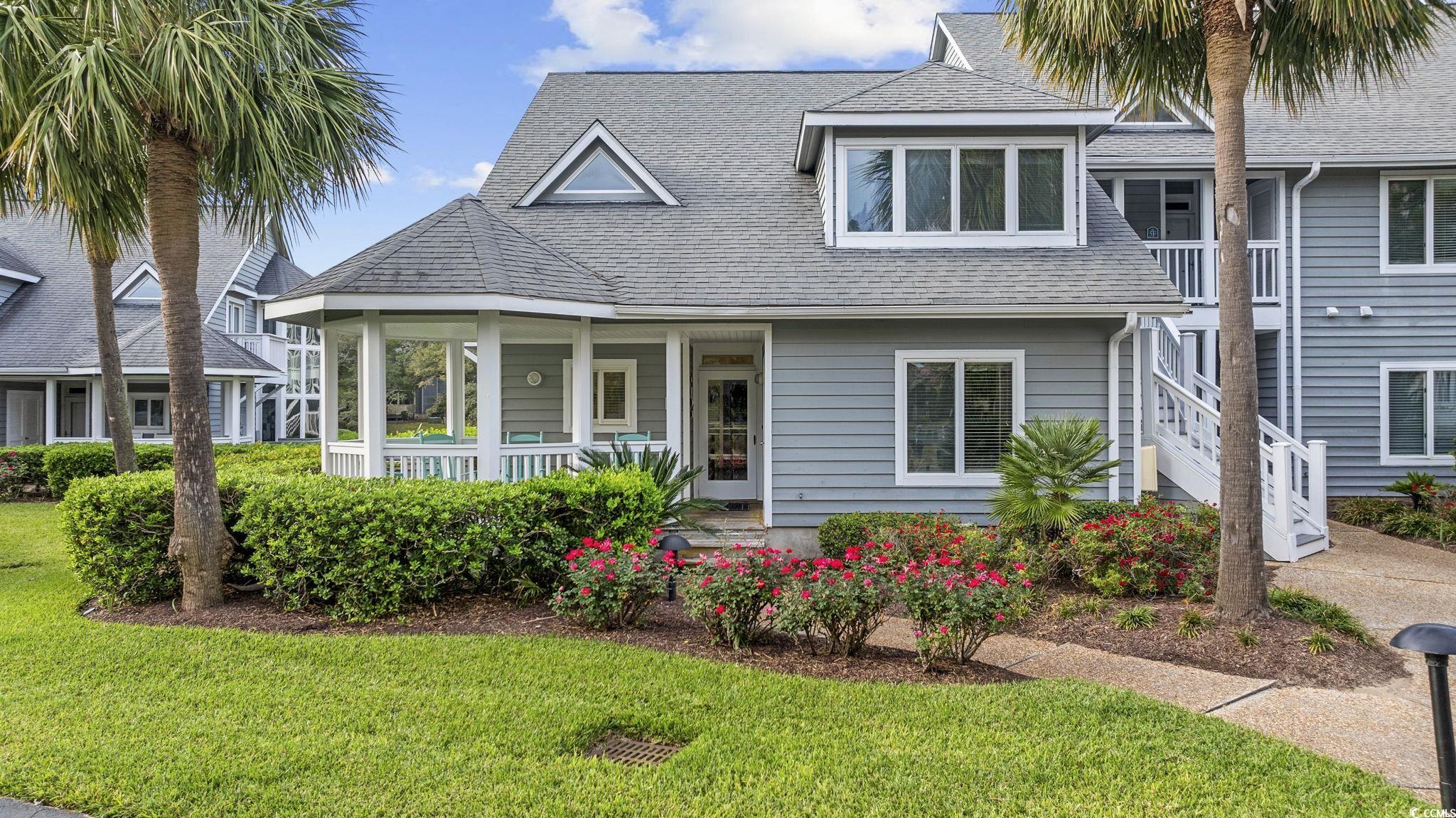 View of front of home featuring a porch and a fron