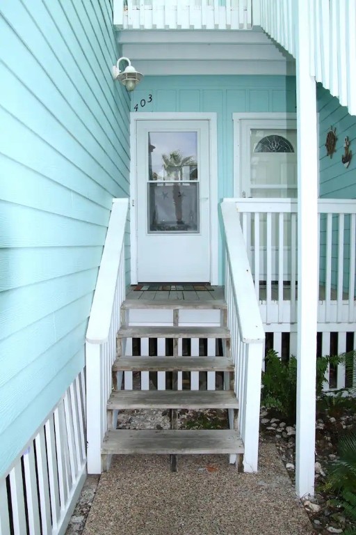 a view of a house with wooden deck and a yard