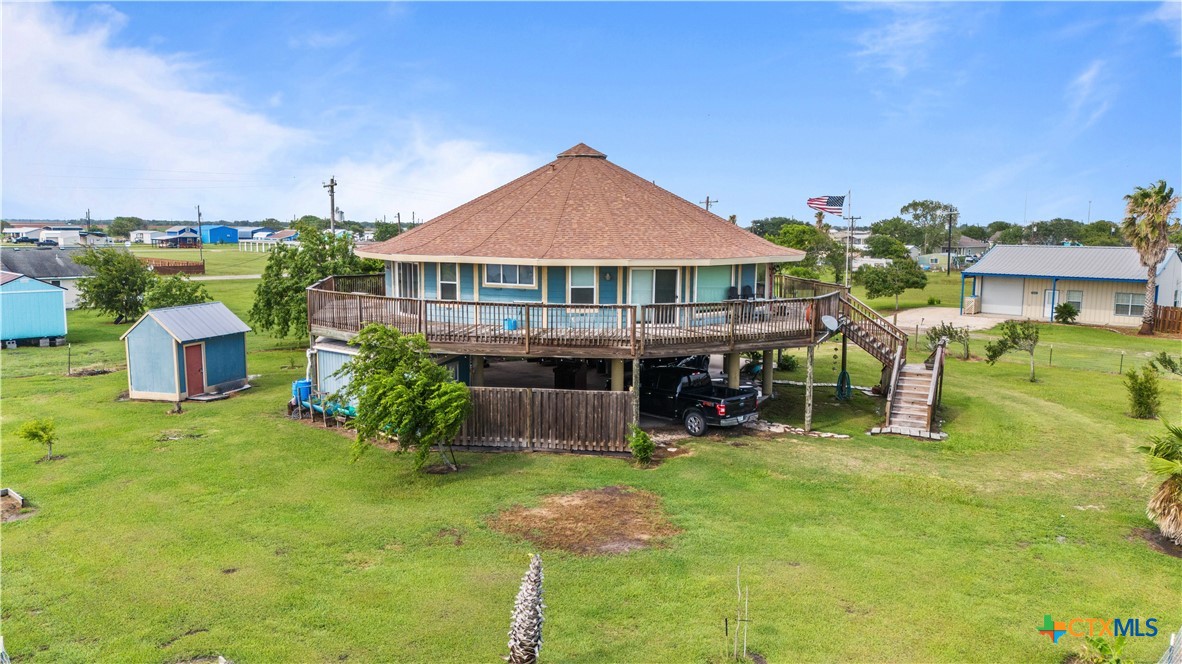 a view of a house with a backyard porch and sitting area