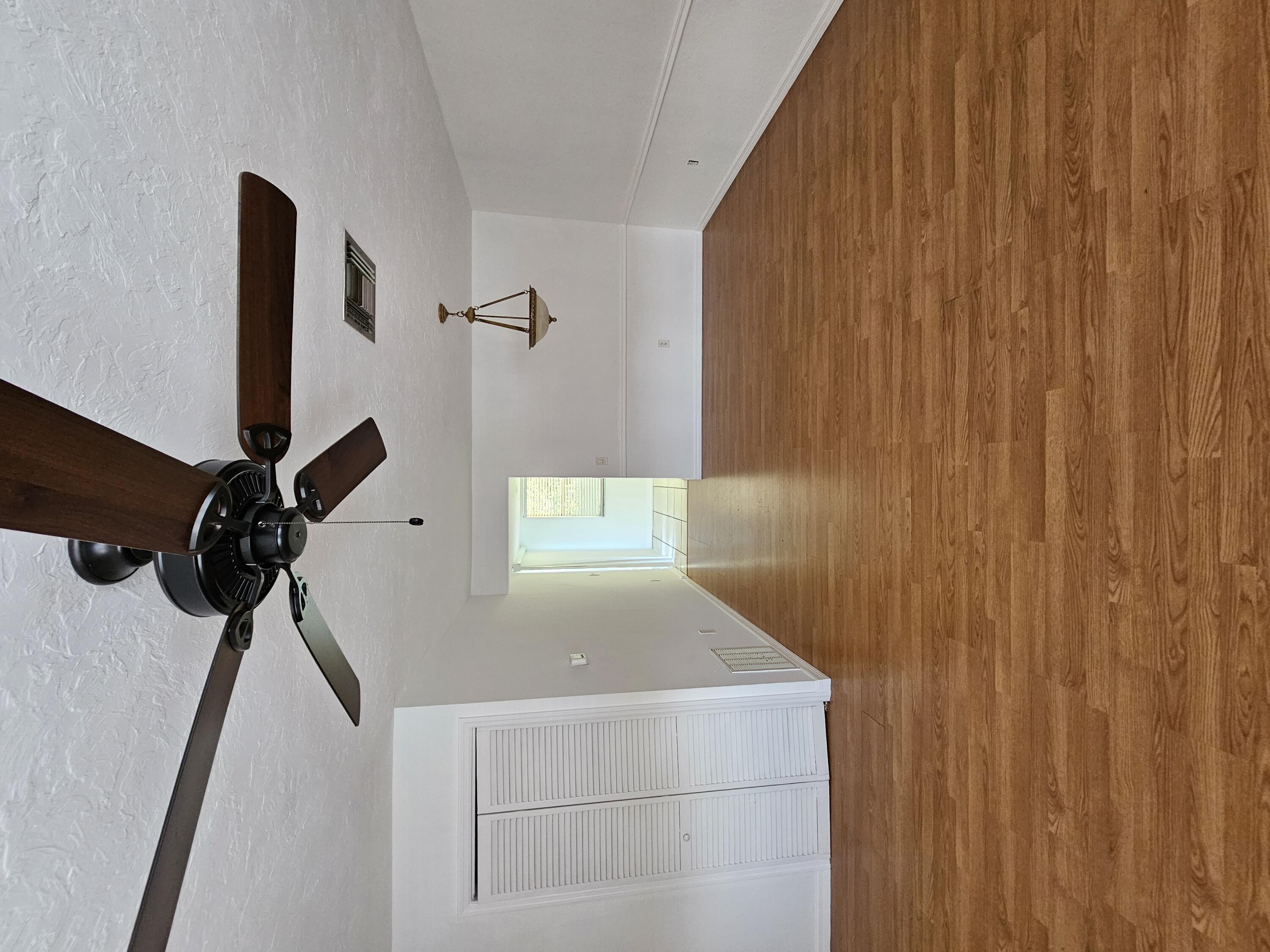 a view of a room with wooden floor