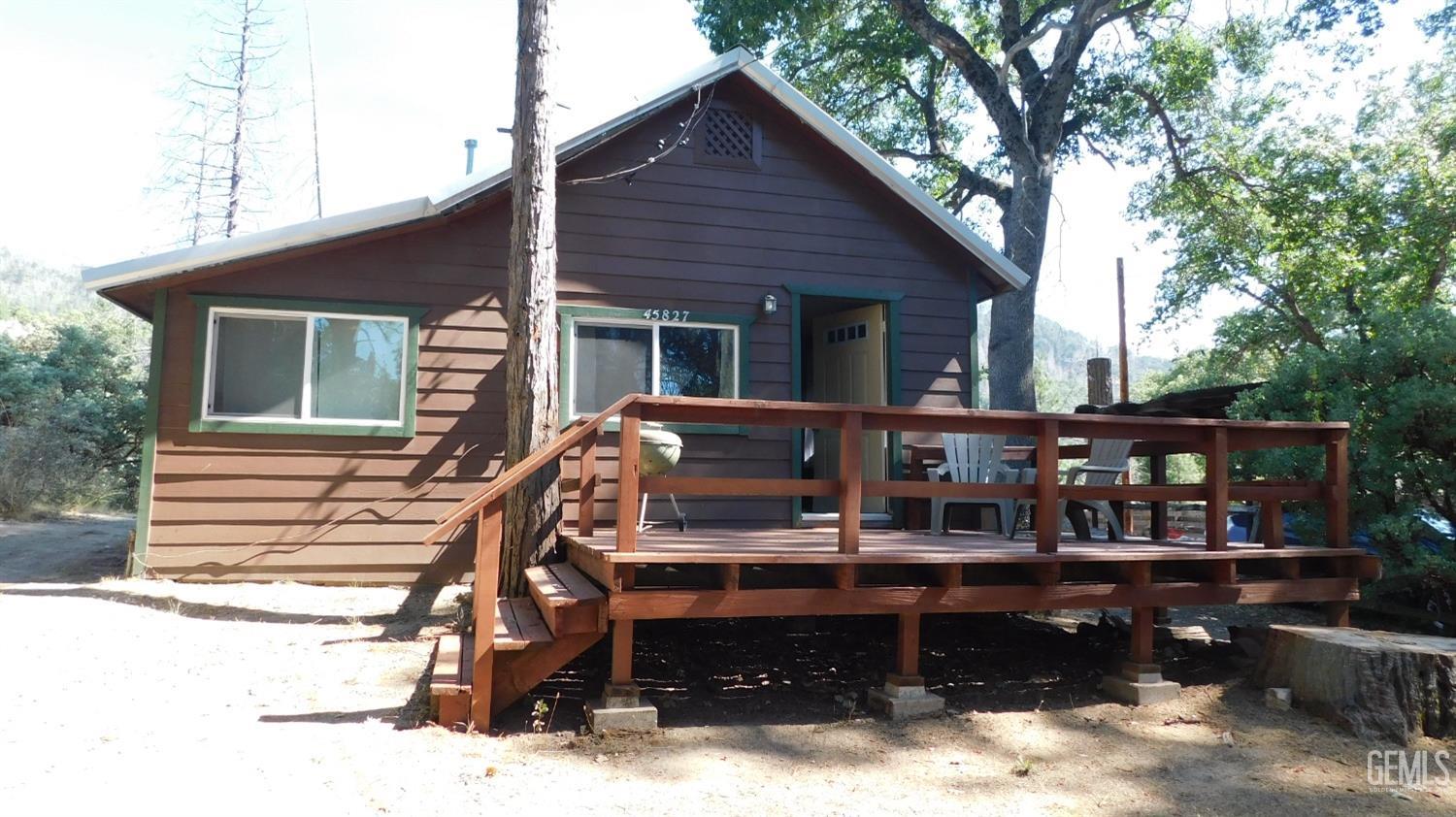 a view of a house with a wooden deck