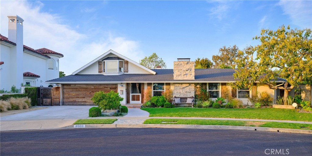 a front view of a house with a yard and trees