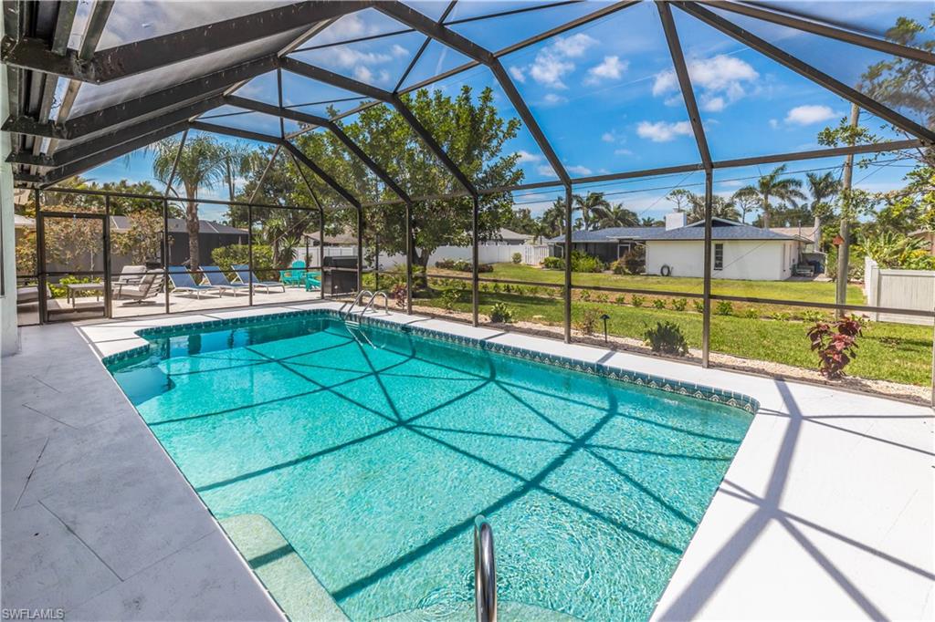 a view of a backyard with a swimming pool