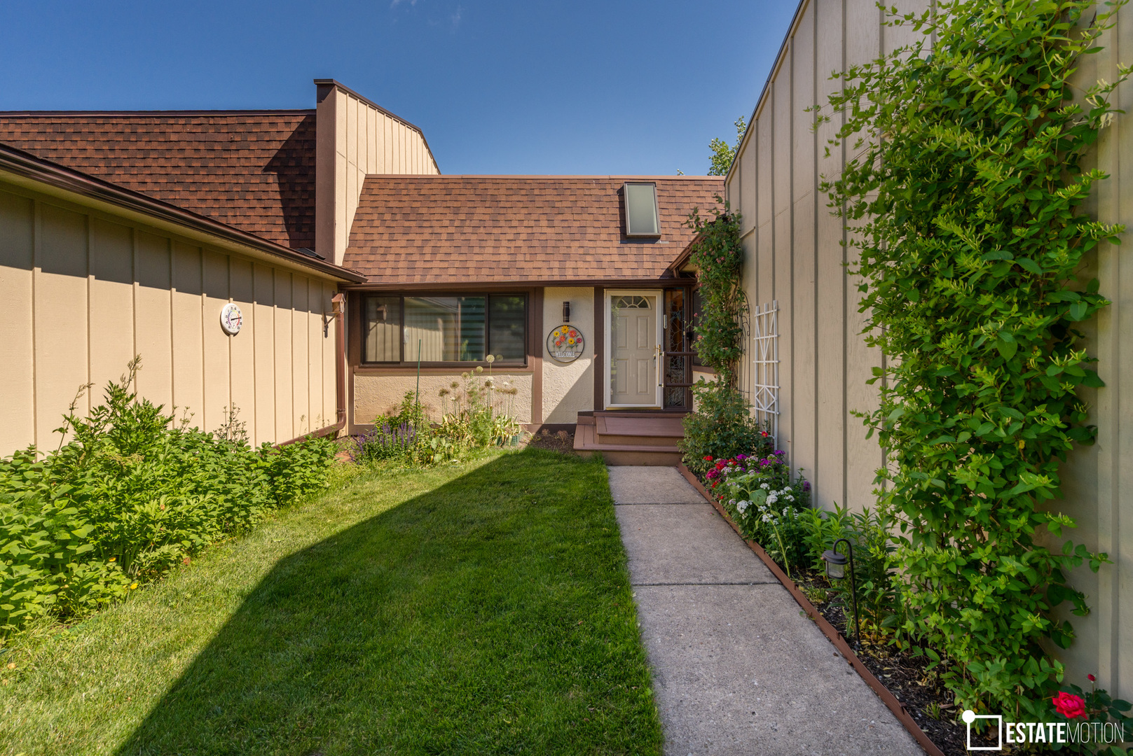 a front view of a house with garden