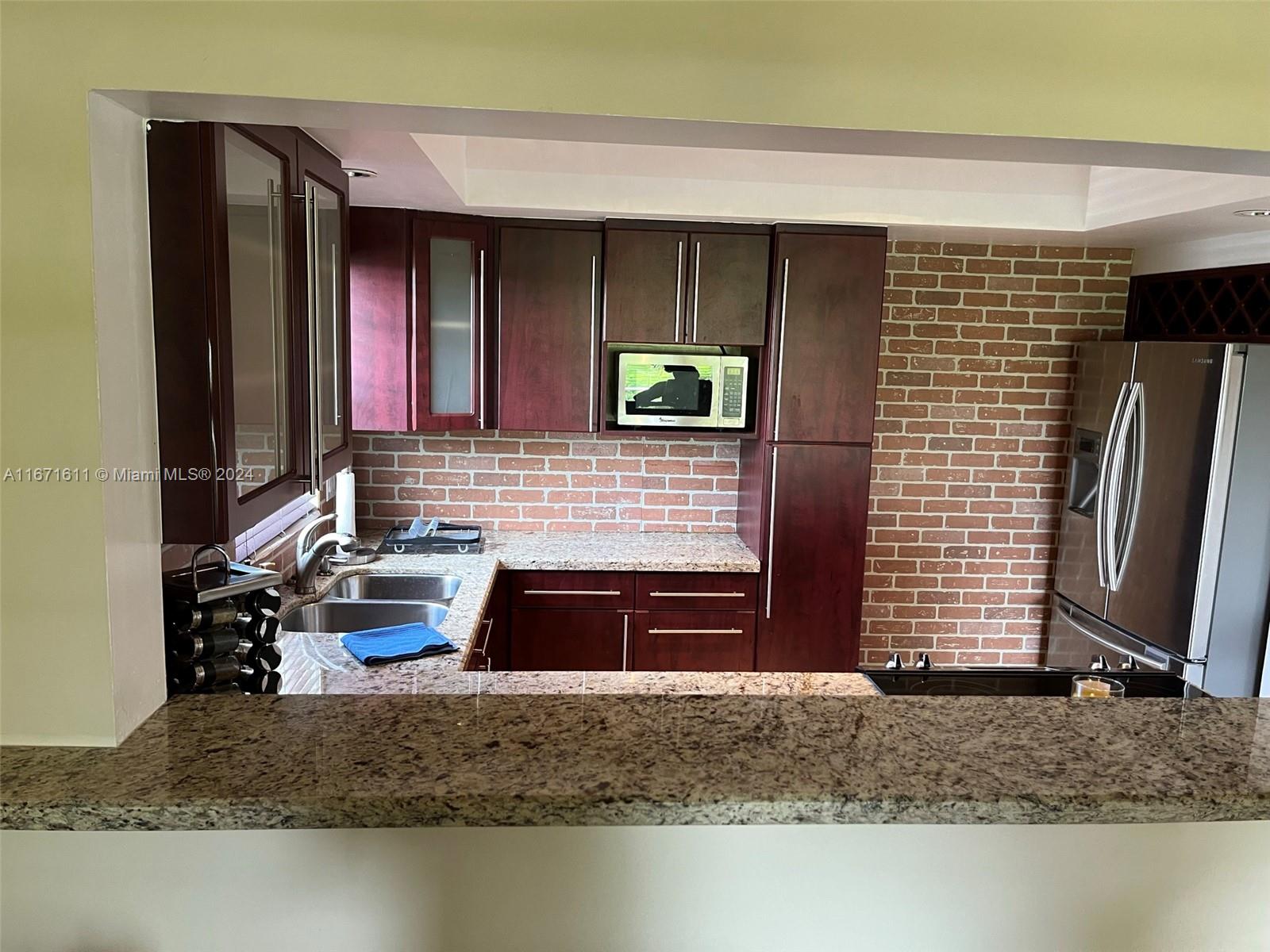 a kitchen with a refrigerator and a sink