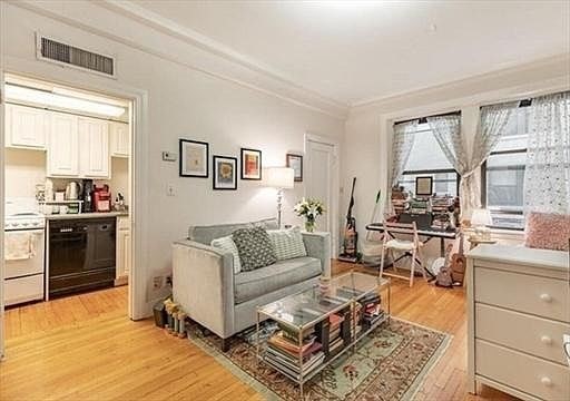 a living room with furniture and a kitchen