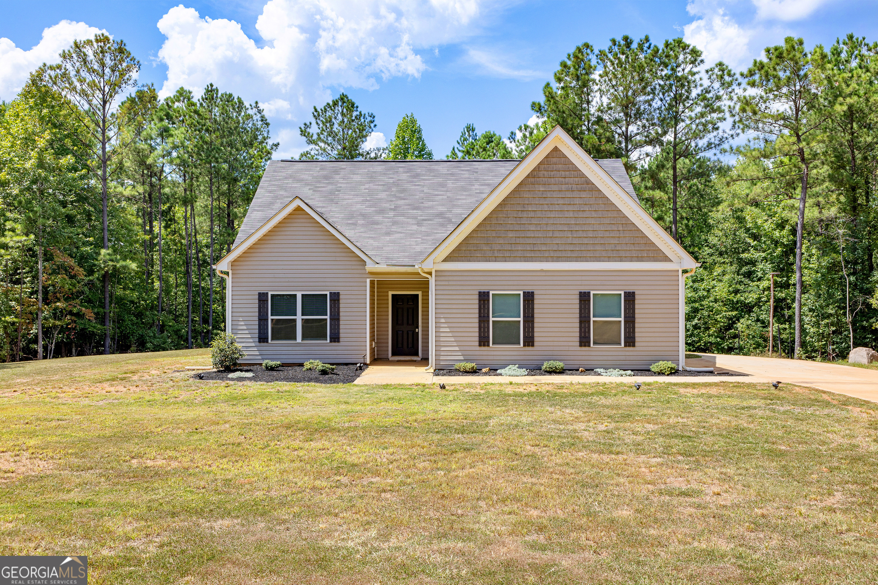 a front view of a house with a yard