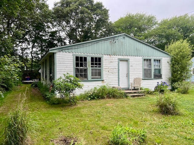 a view of a house with garden and trees