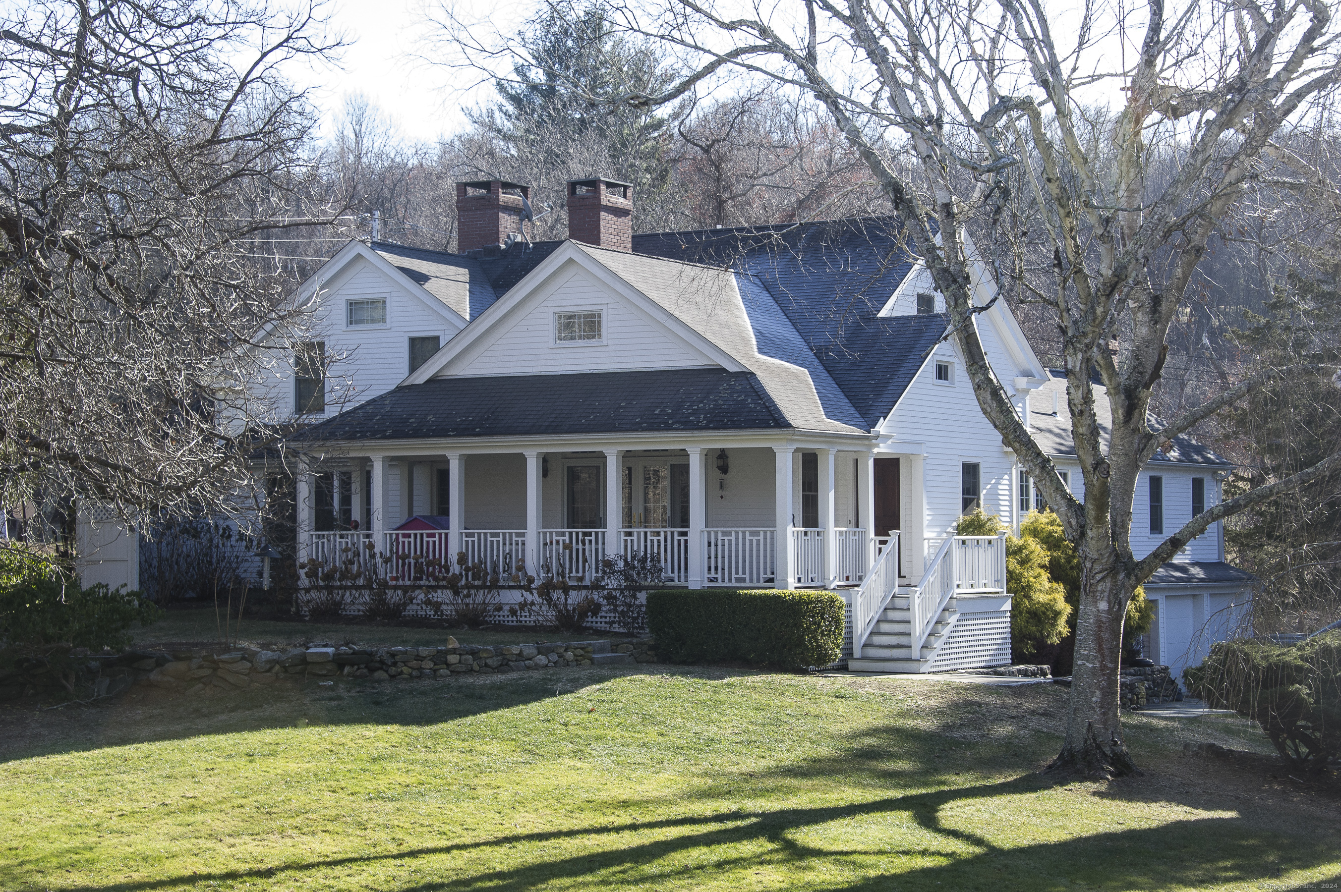 a front view of a house with yard and green space