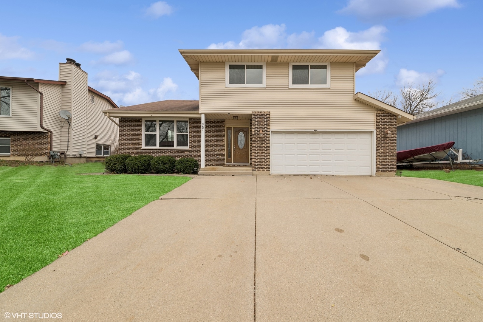 a front view of house with yard and green space