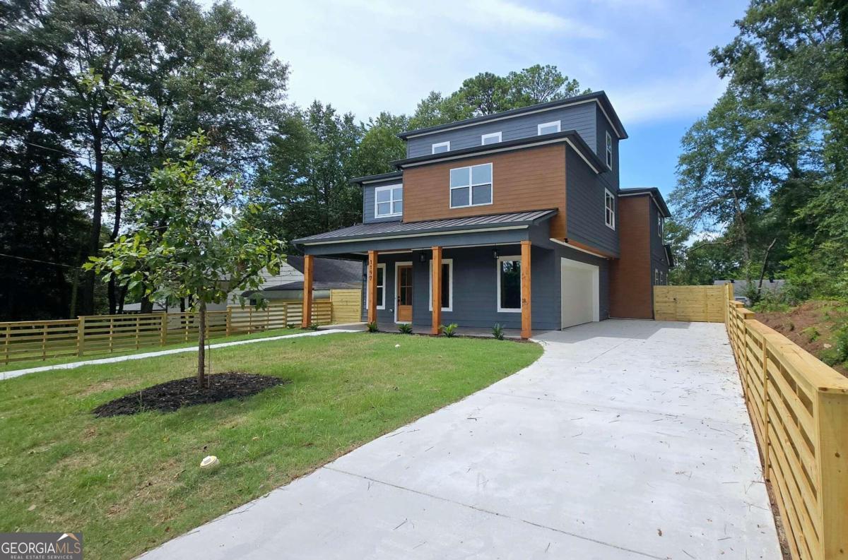 a house with green field in front of it