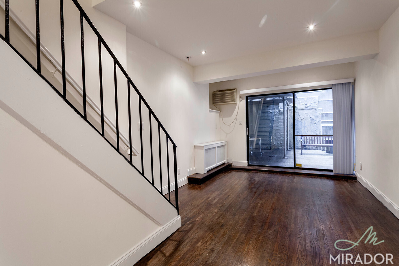 a view of an entryway with wooden floor