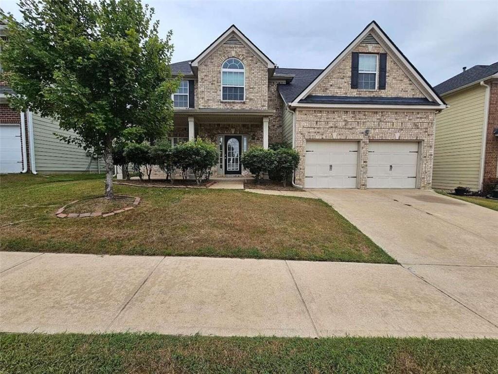 a front view of a house with a yard