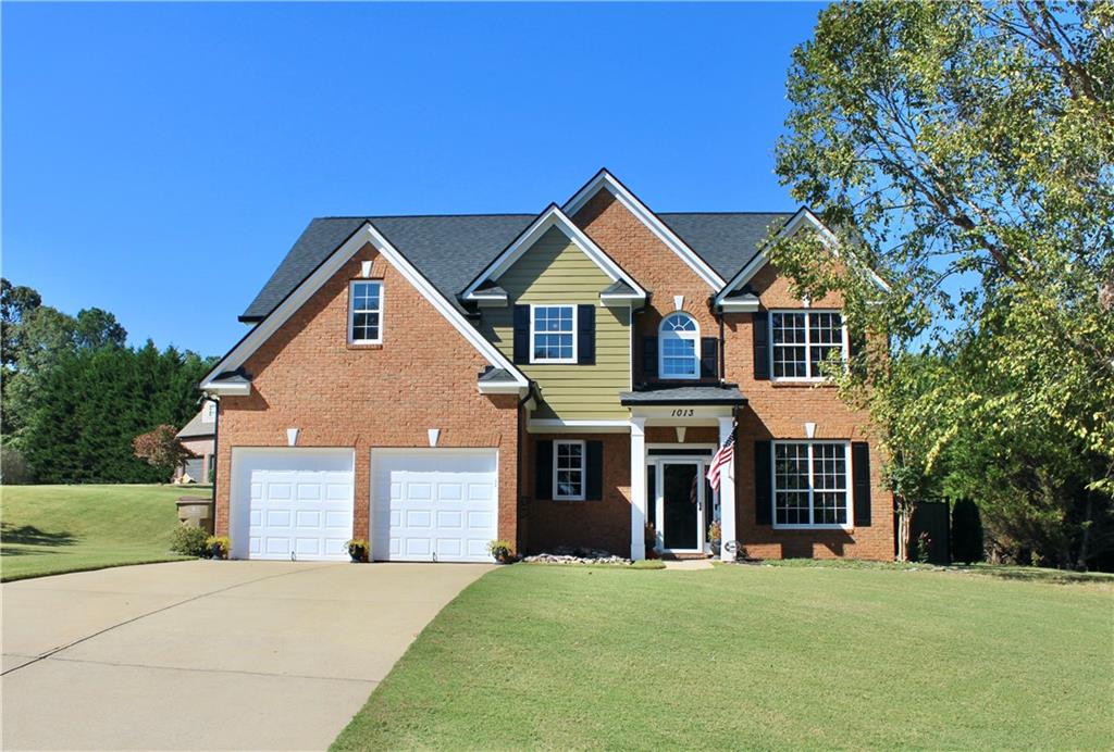 a front view of a house with yard