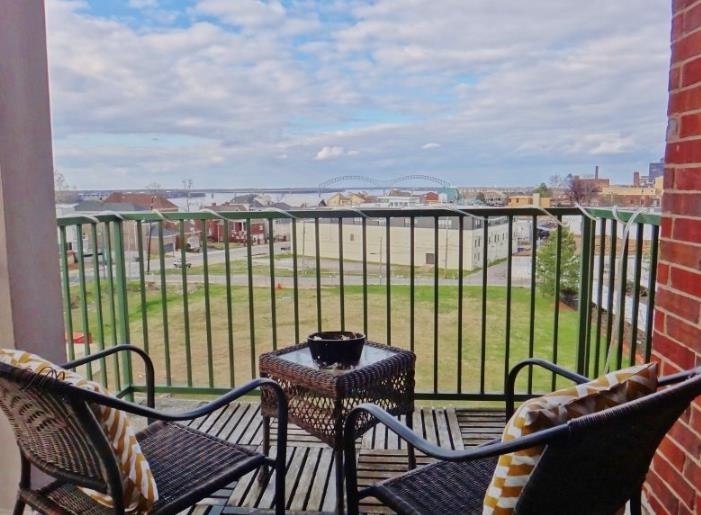 a balcony with table and chairs