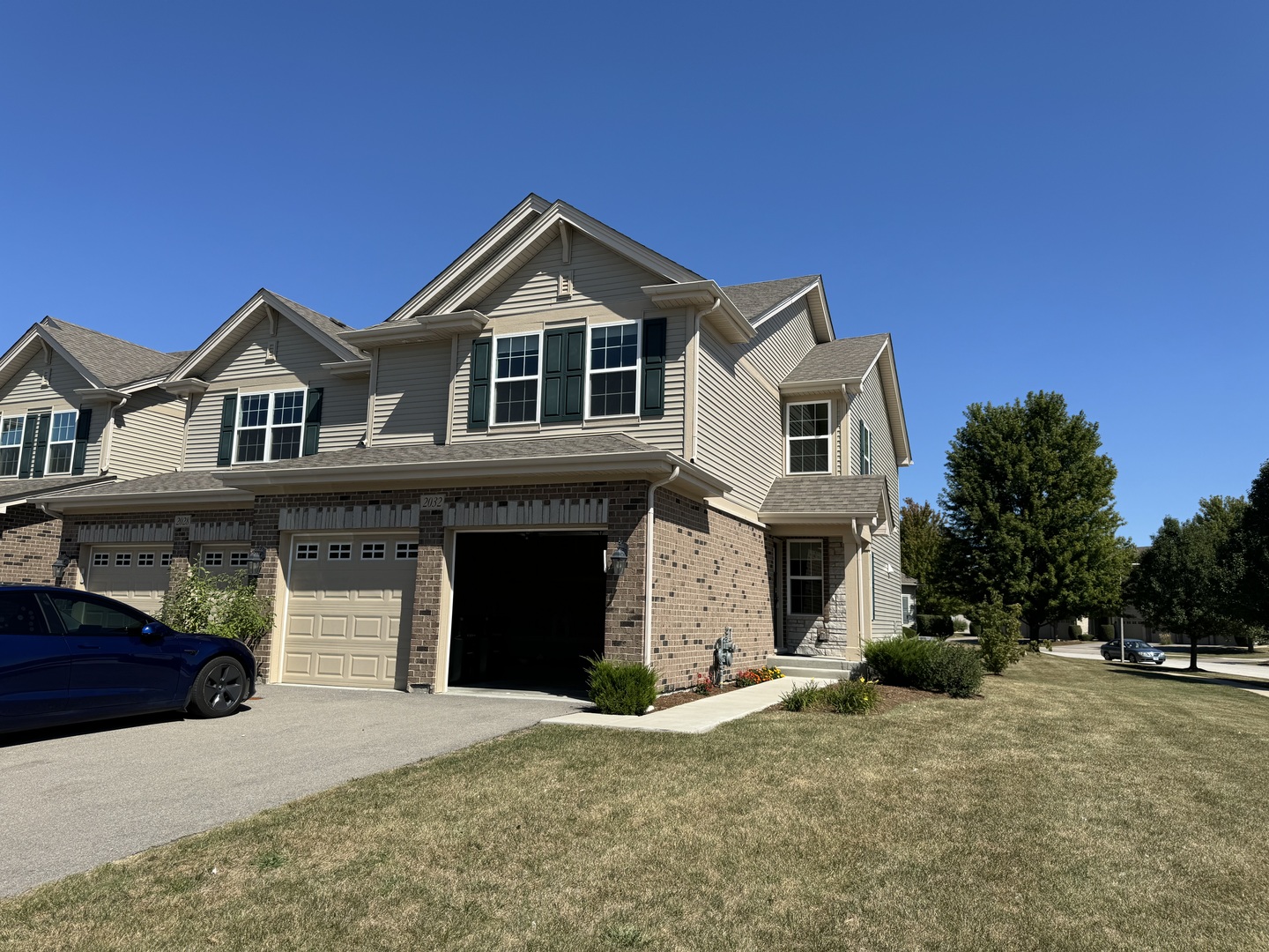 a front view of a house with a yard and garage