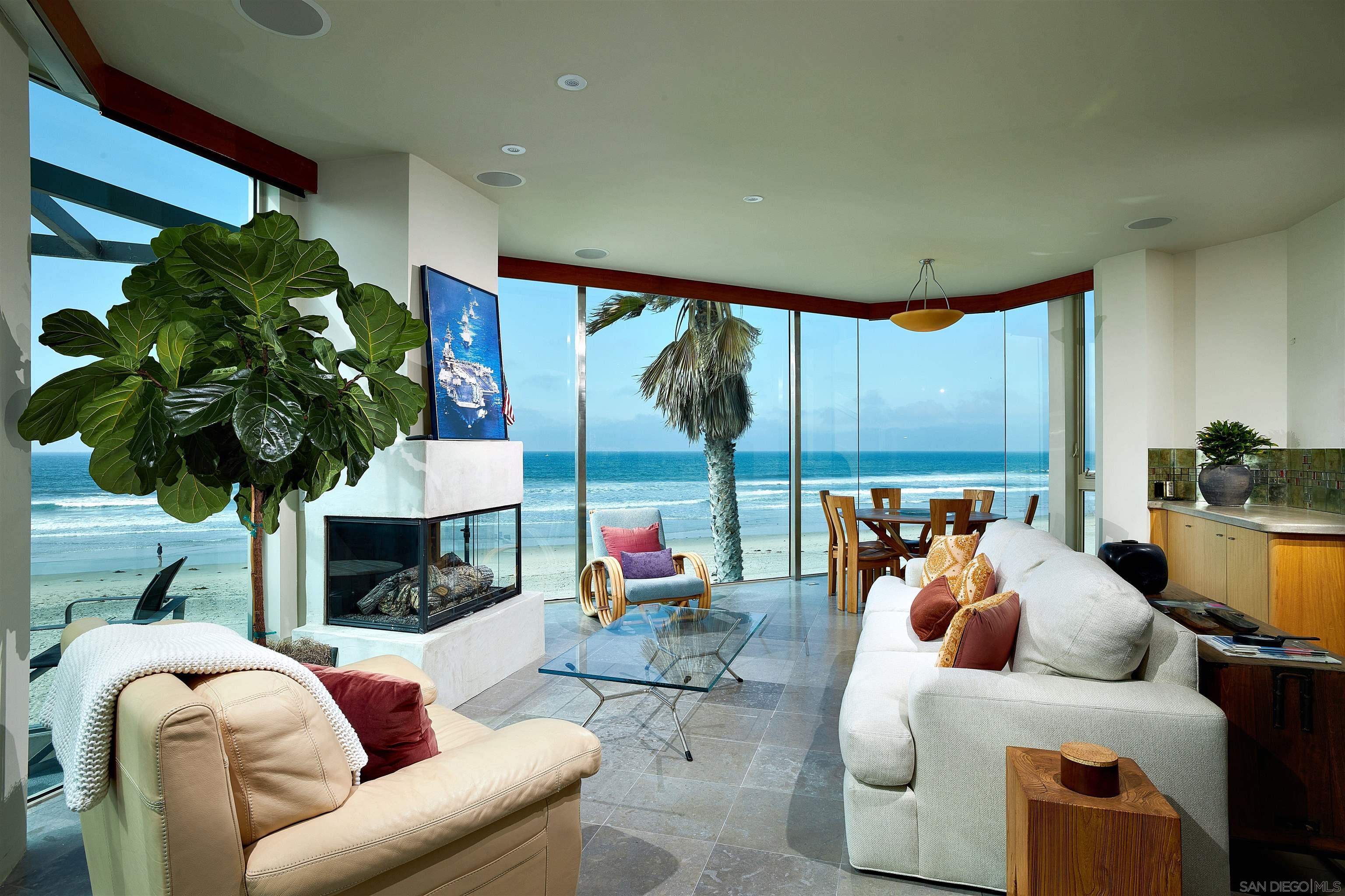 a living room with fireplace furniture and a large window