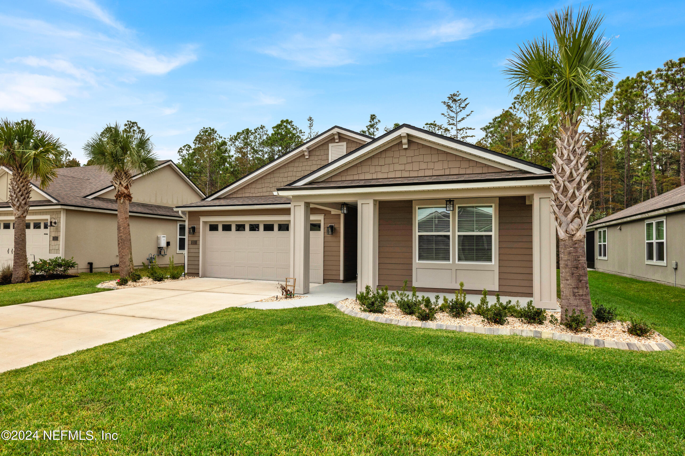 a front view of a house with a garden and yard