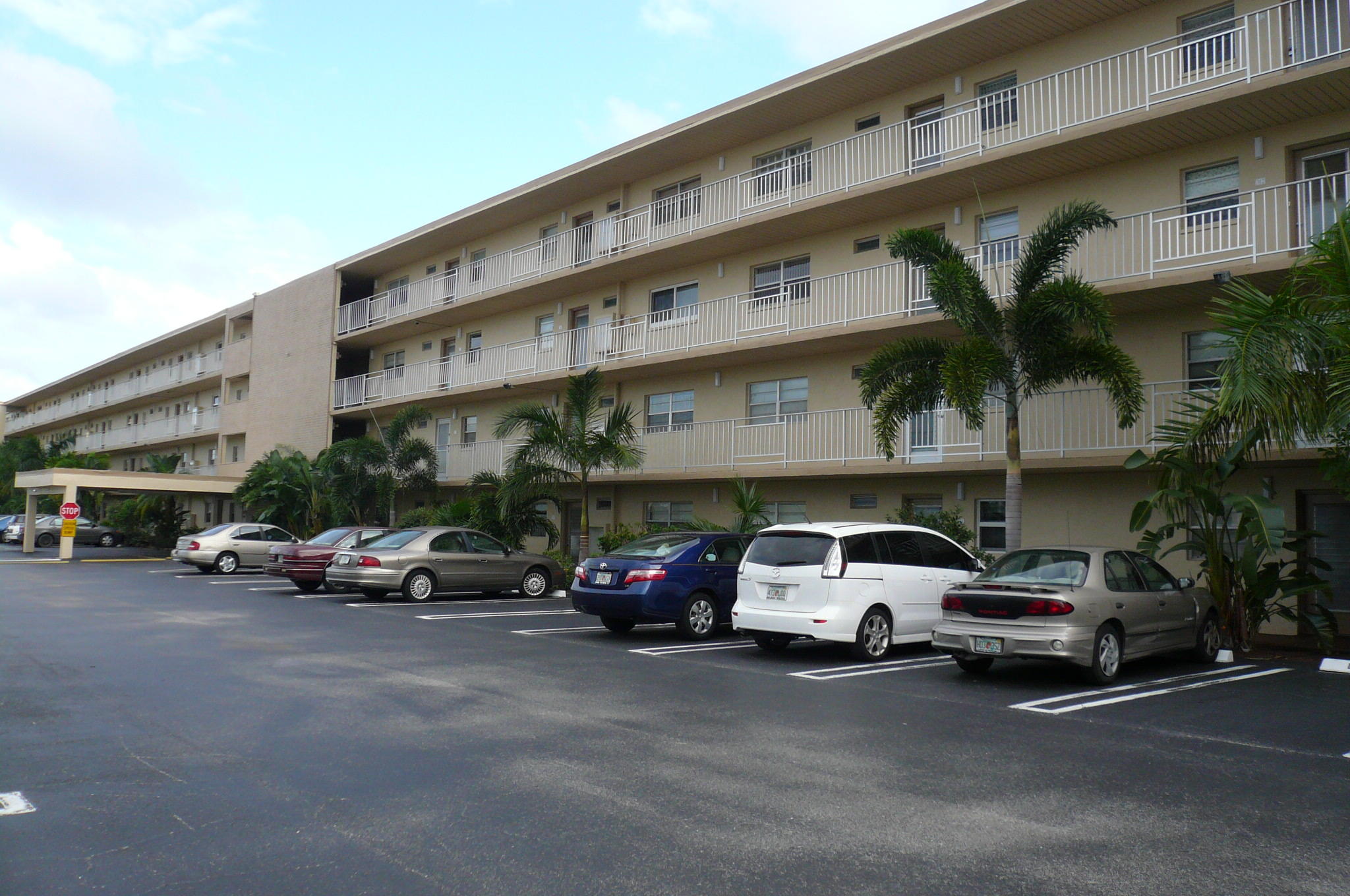 a view of a cars park in front of a building